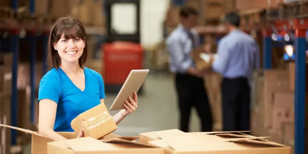 Person holding tablet and box during prescription delivery in Las Vegas