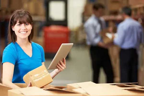 Person holding a tablet and a box for medical delivery tracking